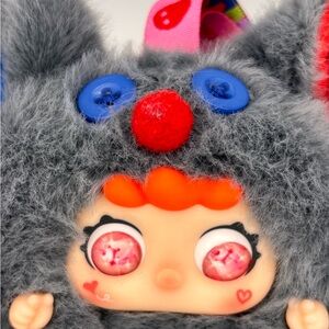 Gray and Blue Stuffed Animal with Red Accents